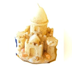Novelty sand castle candle.